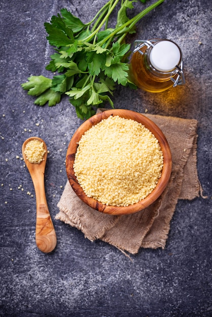 Couscous grain in wooden bowl 