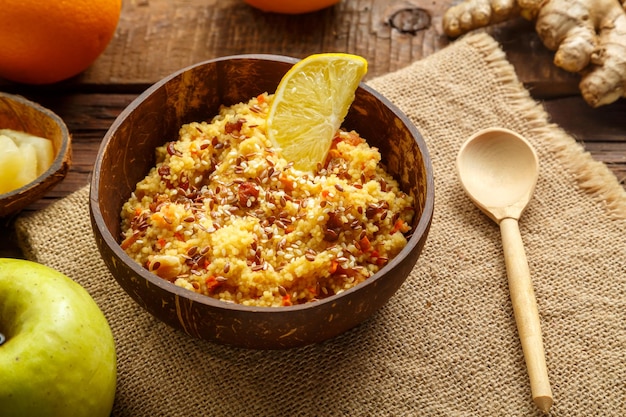 Couscous masfouf with dried fruits and nuts on a linen napkin next to a spoon and fresh fruit