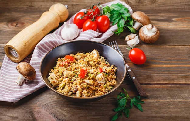 Couscous with turkey, tomatoes, champignon mushrooms, and avocado