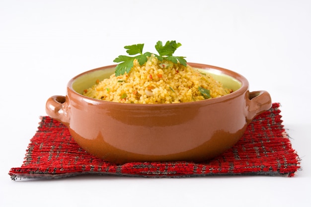 Couscous with vegetables in brown bowl isolated on white