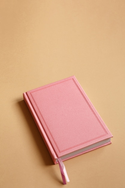 Cover of pink notebook, diary or book on brown paper