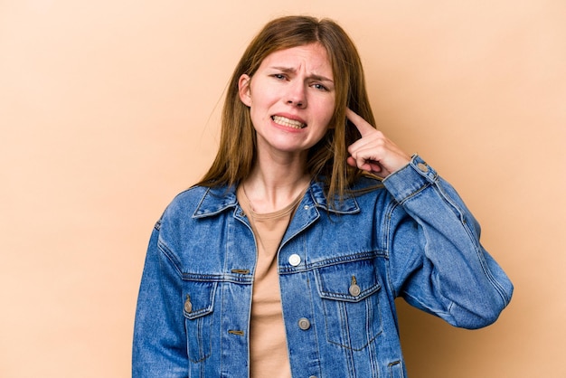 Covering ears with fingers stressed and desperate by a loudly ambient