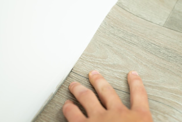 Covering floor with linoleum cover near white inked wall