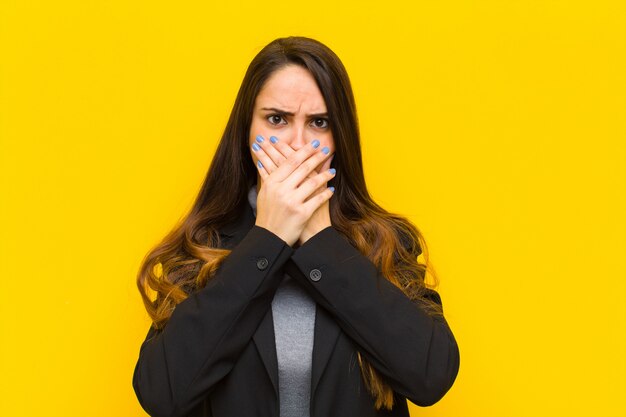 covering mouth with hands with a shocked, surprised expression, keeping a secret or saying oops