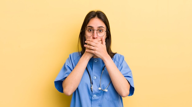 Covering mouth with hands with a shocked