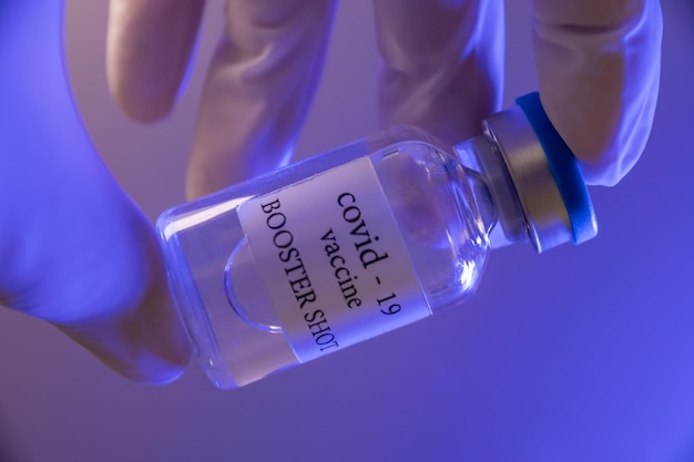 COVID-19 booster vaccine vial. Medicine and health care concept