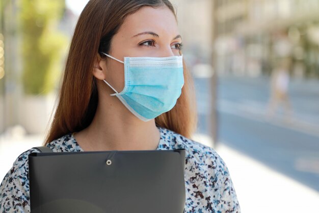 COVID-19 Close UP Unemployed Worried Girl with Surgical Mask Looking for a Job Walking in City Street Delivering Curriculum Vitae