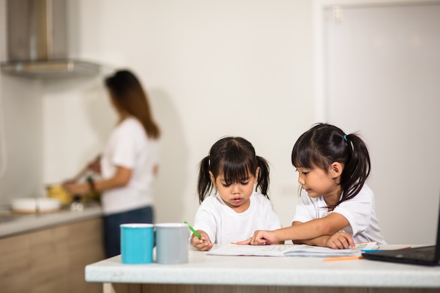 Covid-19 Coronavirus and Learning from home, Home school kid concept. Little children study online learning from home with laptop.