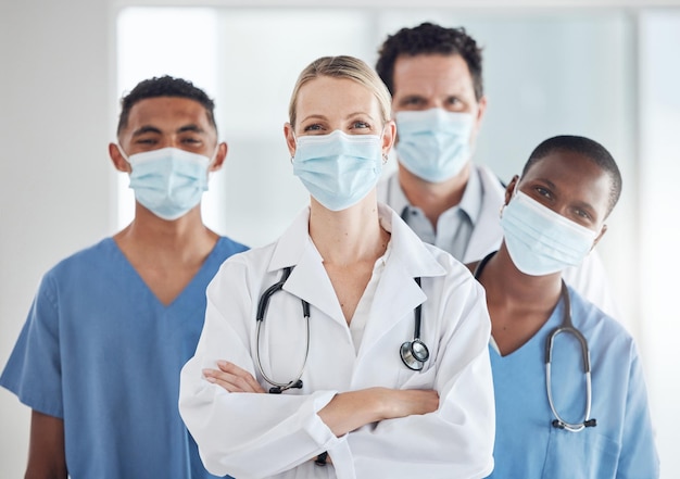 covid 19 face mask and woman doctor with nurses teamwork in hospital compliance in stop of global virus healthcare leadership medical and diversity collaboration in security wellness medicine room
