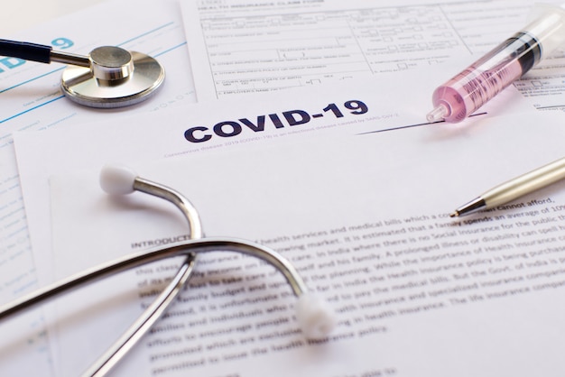 COVID-19 health insurance with syringe and stethoscope