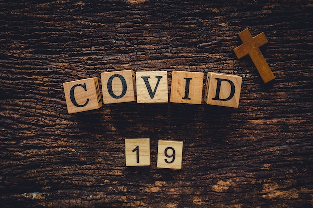 COVID-19 name of Corona virus from Wuhan text word on old wood vintage nature background.