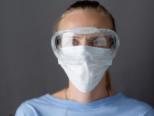 COVID-19 Pandemic Coronavirus. Portrait of a Nurse wearing goggles and face mask