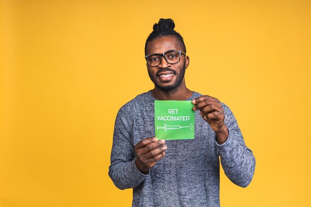 Covid-19 vaccination concept. african american black man after coronavirus vaccine injection shot, vaccinated black guy isolated over yellow background