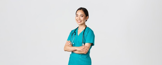 Covid healthcare workers pandemic concept professional confident smiling asian female doctor nurse i...