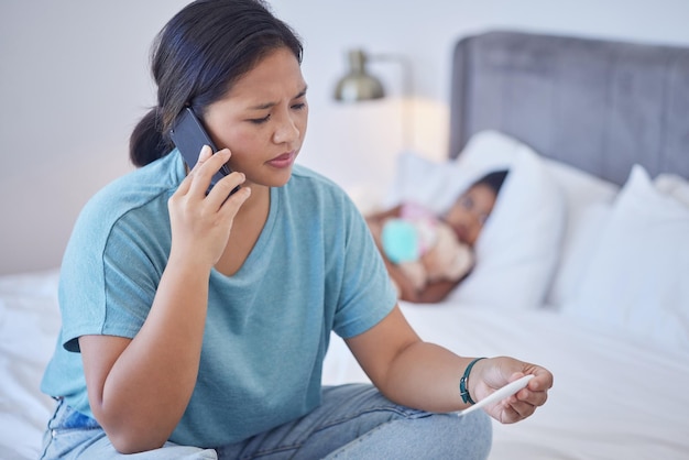 Covid mother and call in bedroom with phone for communication with doctor for child healthcare Anxious worried and stressed Filipino mom on smartphone for advice on thermometer reading