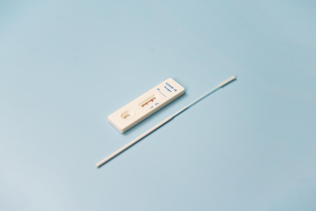 Photo covid rapid antigen test kit positive test result using rapid testing device for covid virus