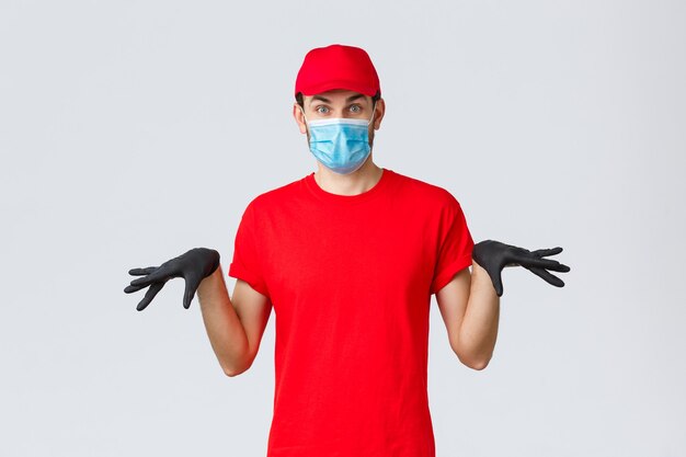 Covid selfquarantine online shopping and shipping concept funny courier in black rubber gloves and f...