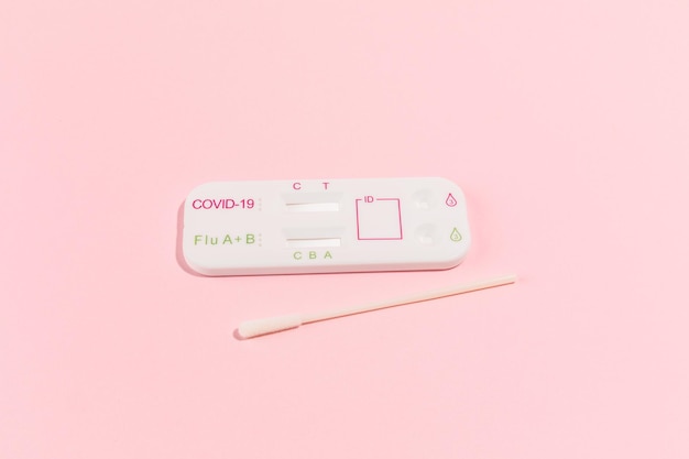 Covid test kit on pink background