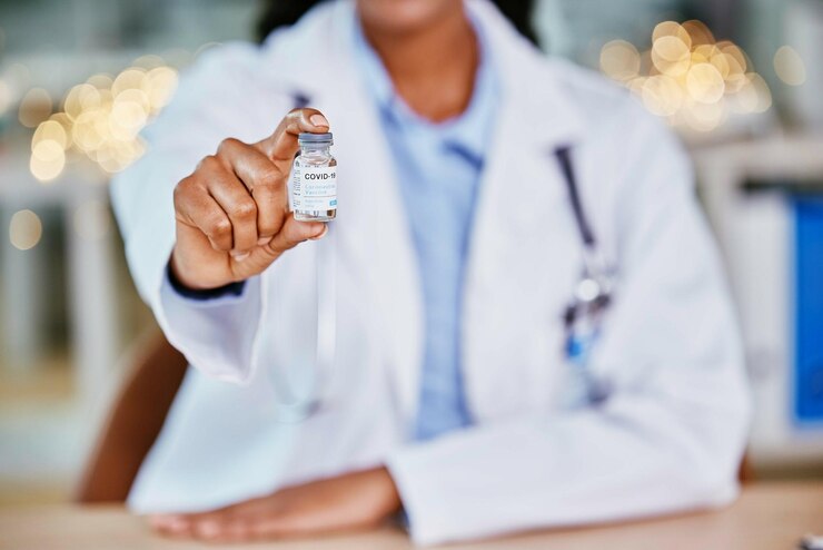 Photo covid vaccine and doctor hands for healthcare solution compliance and policy in office bokeh hospital clinic or pharmacy professional with corona virus in liquid container or product background