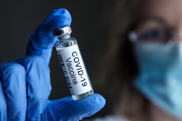 COVID19 coronavirus vaccine in researcher hand closeup