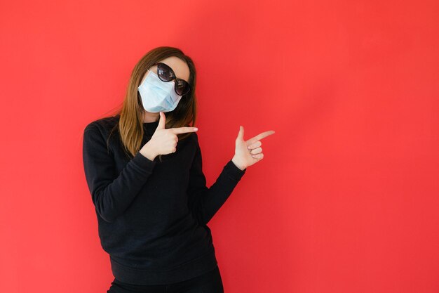 COVID19 Pandemic Coronavirus Young girl on red background face mask protective Coronavirus Disease