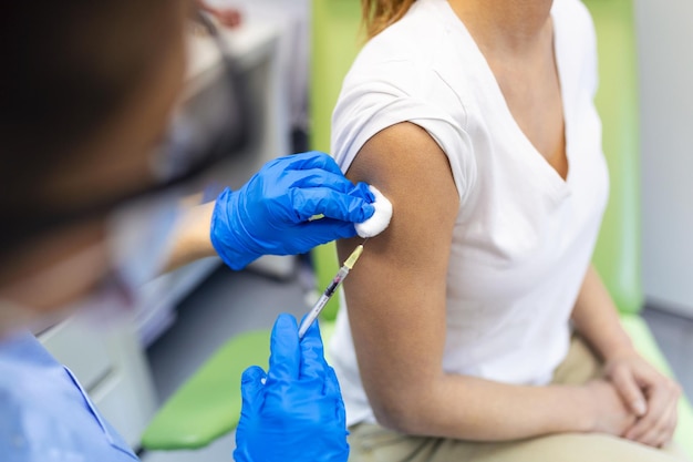 Covid19 vaccination patient getting vaccinated against\
coronavirus receiving covid vaccine intramuscular injection during\
doctors appointment in hospital corona virus immunization