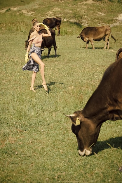 Cow woman in countryside pasture ecology