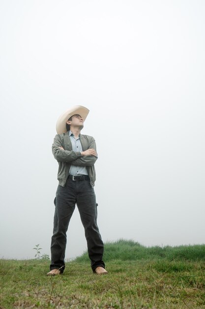 Cowboy Delight Man in Mexican Hat and Boots amid Foggy Landscape