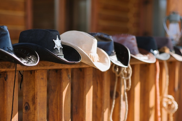 Photo a cowboy hats composition on wooden house terrace on sunny day