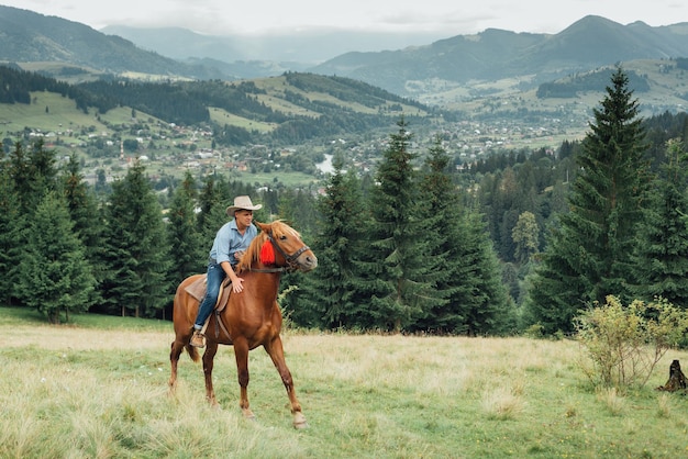 Cowboy portrait in beautiful countryside mountains landscape