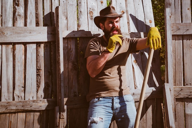 Cowboy portrait farmer planting in the vegetable garden agricultural land