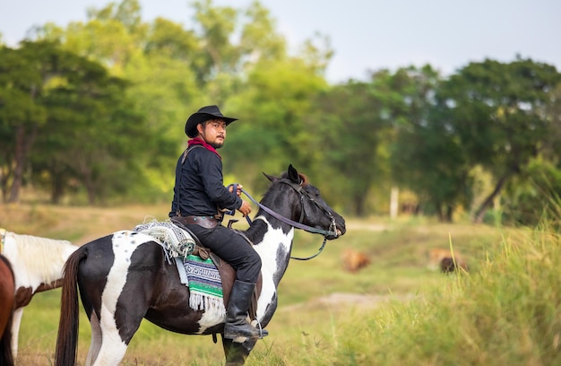 Cowboy's way of life include riding a horse around locales