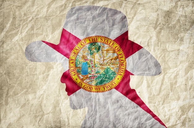 Cowboy silhouette with florida flag on wrinkled paper\
background