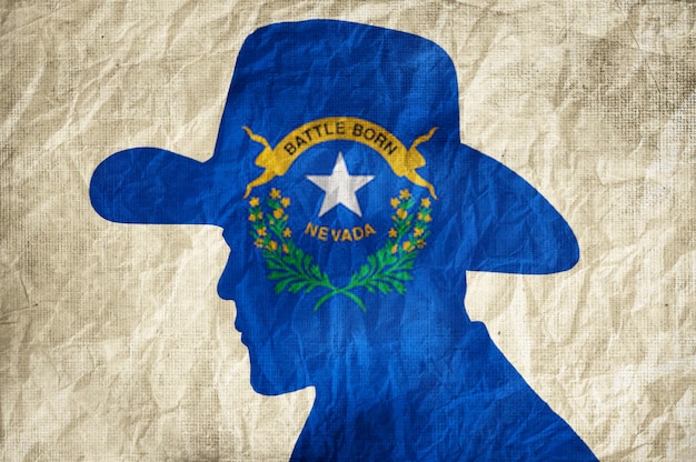 Cowboy silhouette with Nevada flag on wrinkled paper background