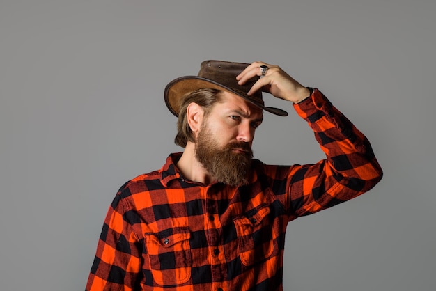 Cowboy style handsome bearded man in cowboy hat sexy western man with hat