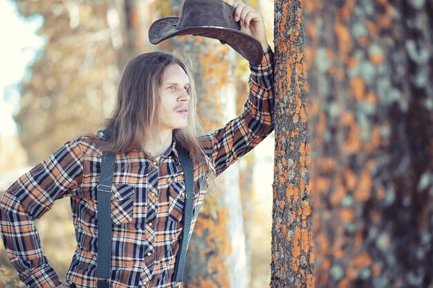 Cowboy with hat in a field in autumn