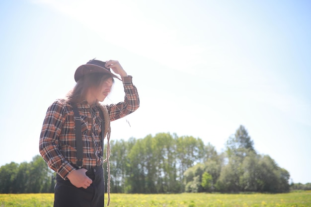 Cowboy with hat in a field in autumn