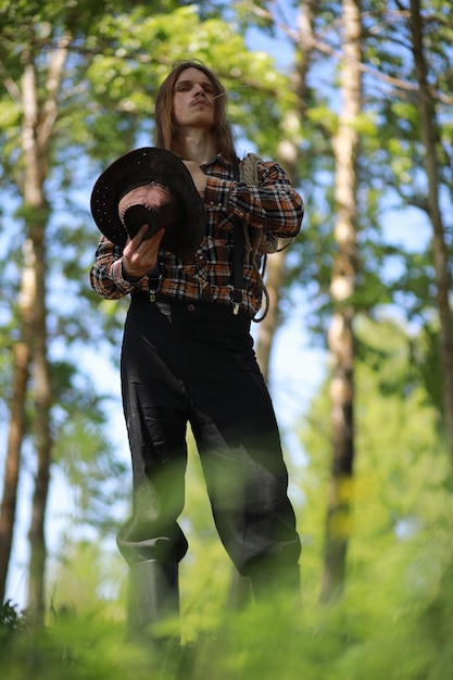 Cowboy with hat in a field in autumn