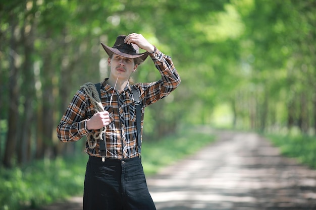 Cowboy with hat in a field in autumn