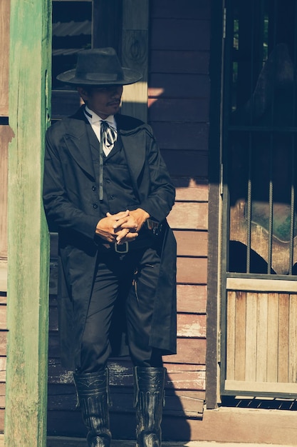 cowboy with hat standing on the grown.