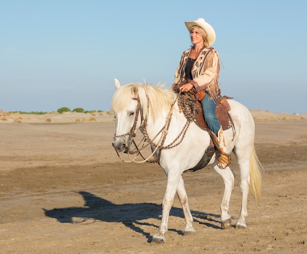 cowgirl on camargue horse