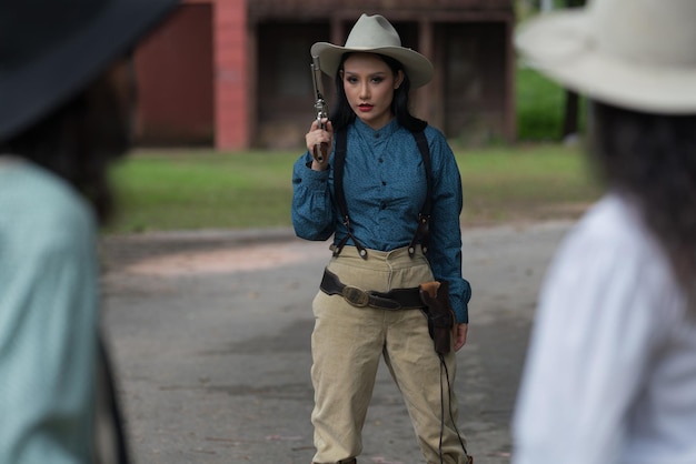 Cowgirl fashion women with gun