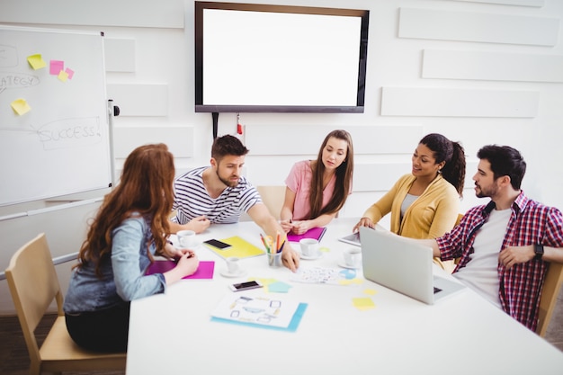 Coworkers discussing in meeting at creative office