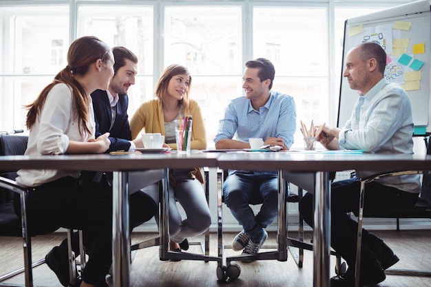 Coworkers discussing in meeting room