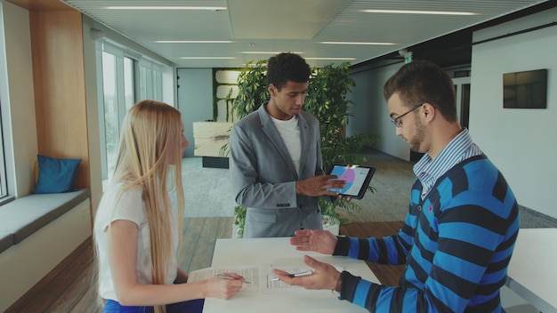 Coworkers discussing in an office