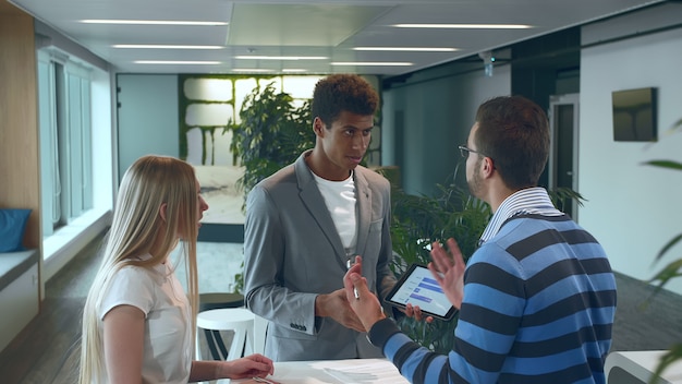 Coworkers discussing in an office