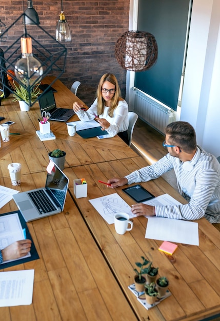 Coworkers discussing project in the office