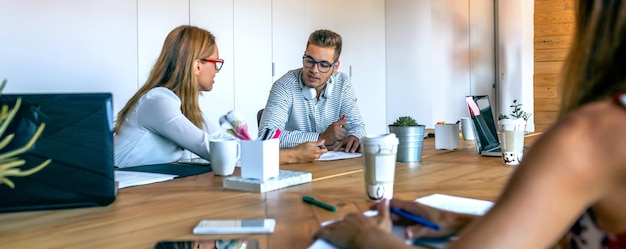 Coworkers discussing project in the office