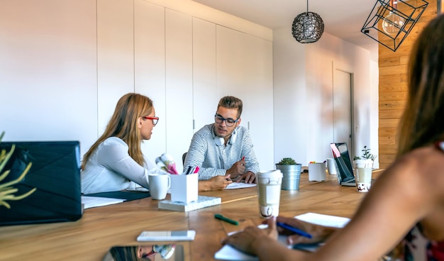 Coworkers discussing project in the office