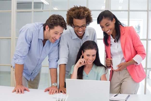 Coworkers interacting with laptop computer